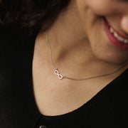 Elegant Silver Necklace Featuring a Stunning Infinity Pendant